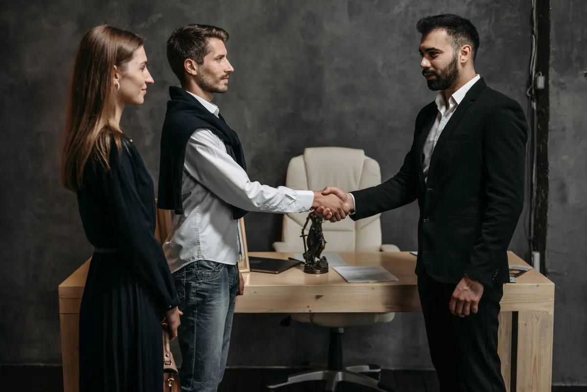 Professional handshake across the meeting table
