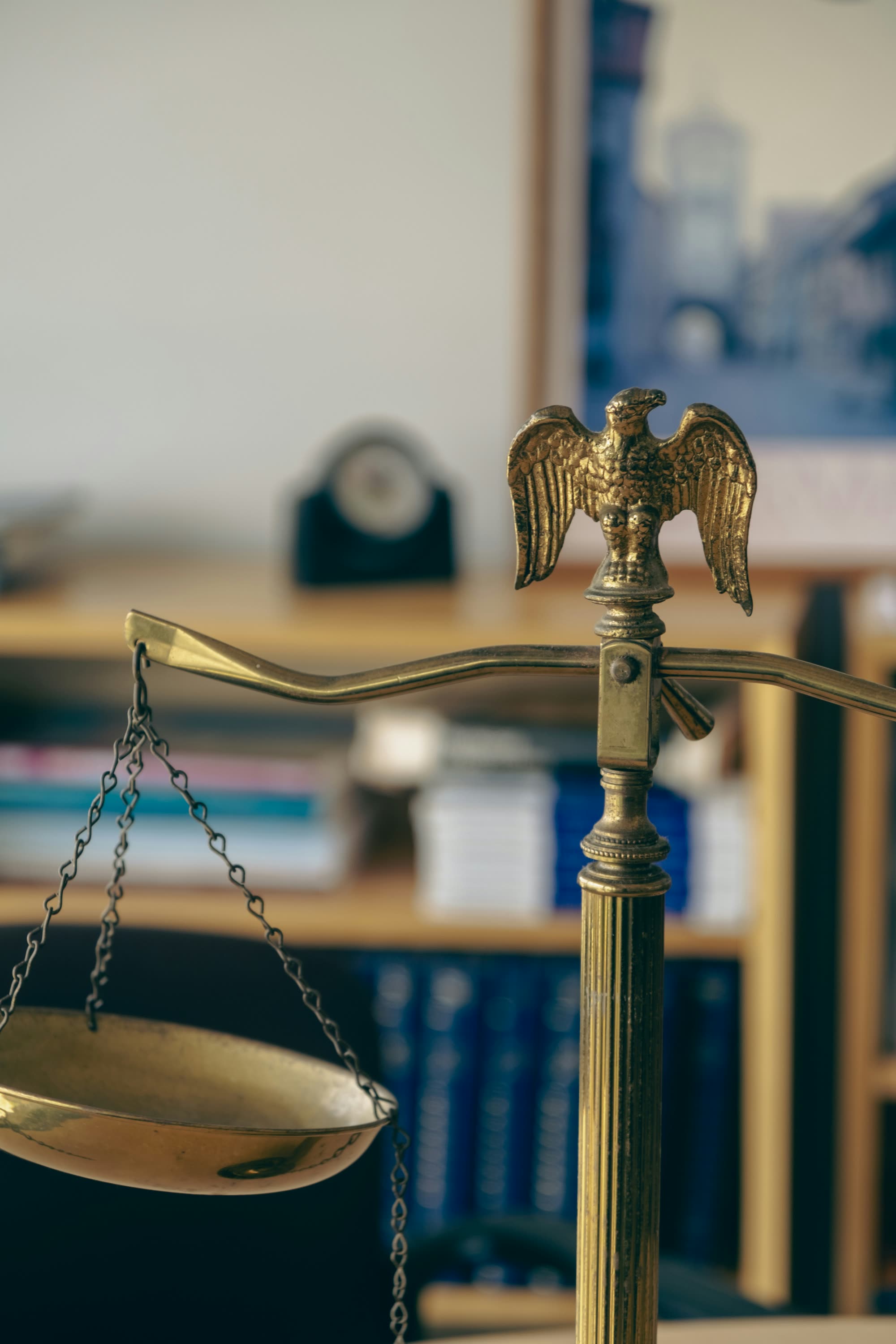 Brass scales of justice with eagle finial on a law office desk
