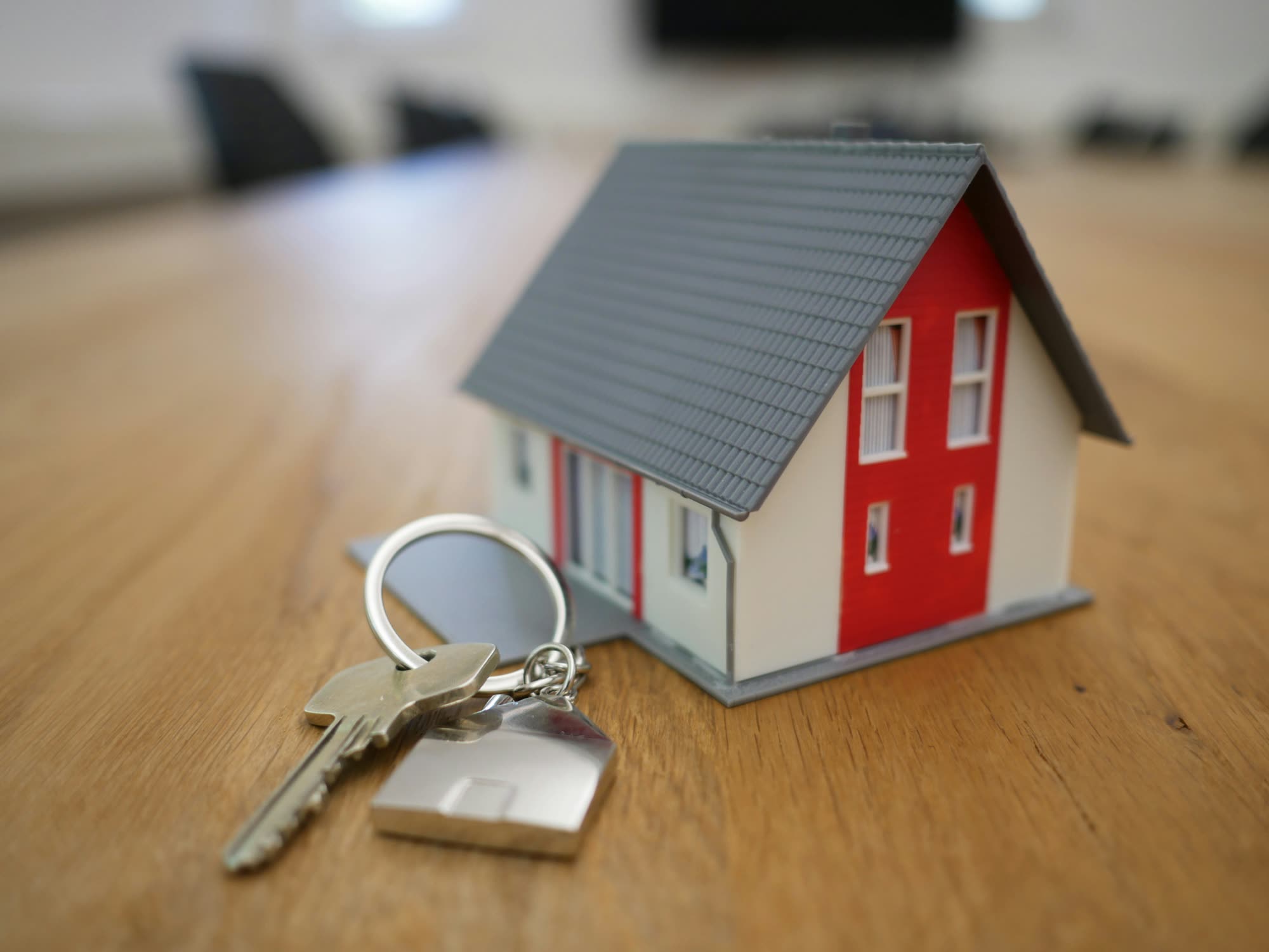 White and red house miniature on a wooden table